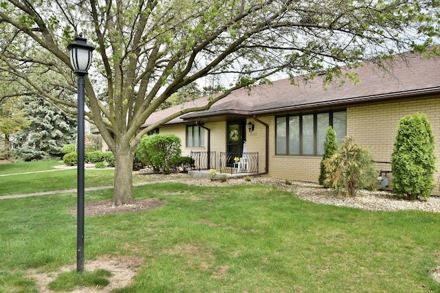 15608 Petunia Ct, Orland Park, IL 60462 - view of front of house featuring brick siding, a front lawn, and a shingled roof