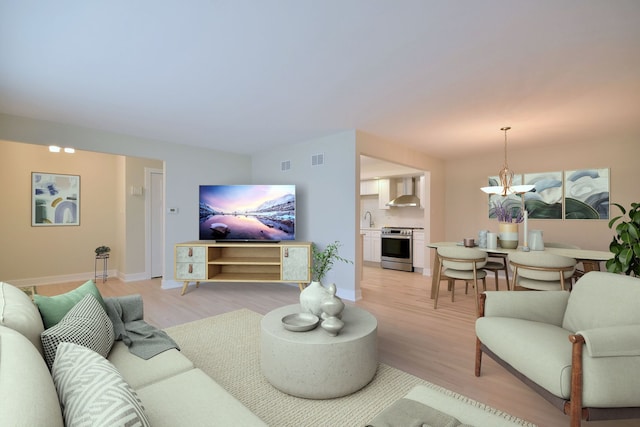 15608 Petunia Ct, Orland Park, IL 60462 - living area with light wood-style flooring, a chandelier, and baseboards