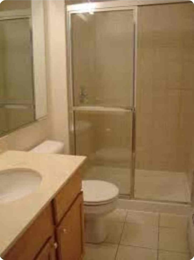 1238 W Pratt Blvd Unit 1A, Chicago, IL 60626 - bathroom featuring toilet, a stall shower, tile patterned flooring, and vanity