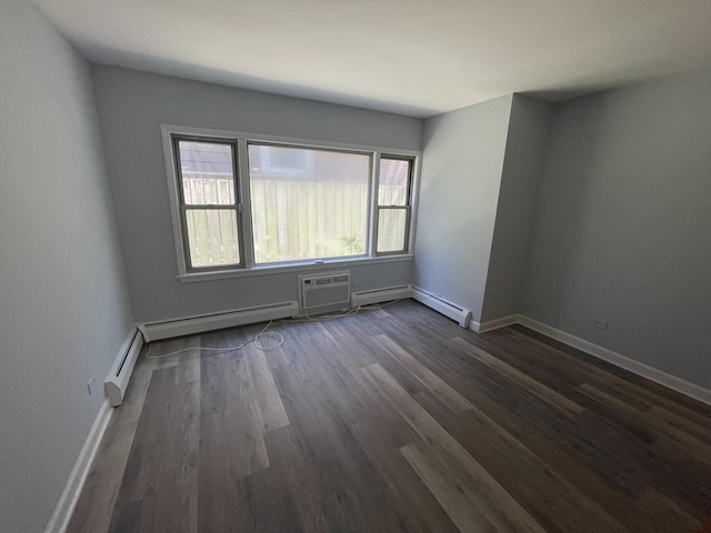 1238 W Pratt Blvd Unit 1A, Chicago, IL 60626 - spare room featuring a wall mounted air conditioner, dark wood-style floors, and baseboard heating