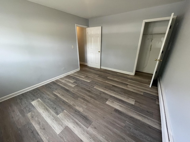 1238 W Pratt Blvd Unit 1A, Chicago, IL 60626 - unfurnished bedroom with wood finished floors, a closet, a baseboard radiator, and a walk in closet