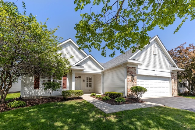 1468 W Grand Haven Rd, Romeoville, IL 60446 - view of front facade with driveway, a front lawn, brick siding, and an attached garage