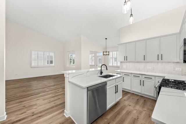 1468 W Grand Haven Rd, Romeoville, IL 60446 - kitchen with stainless steel appliances, a sink, light wood-type flooring, an island with sink, and tasteful backsplash