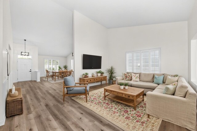 1468 W Grand Haven Rd, Romeoville, IL 60446 - living area with high vaulted ceiling, light wood-style flooring, and a chandelier