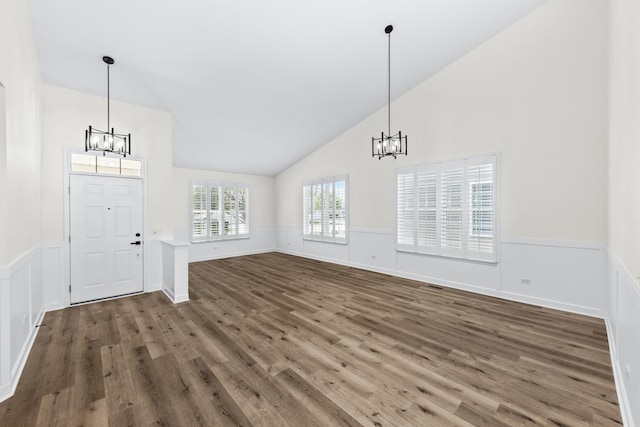 1468 W Grand Haven Rd, Romeoville, IL 60446 - foyer entrance with a chandelier, wood finished floors, a wainscoted wall, and high vaulted ceiling
