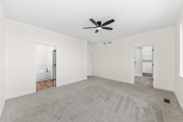 1468 W Grand Haven Rd, Romeoville, IL 60446 - unfurnished bedroom featuring carpet floors, baseboards, a walk in closet, ensuite bathroom, and a closet