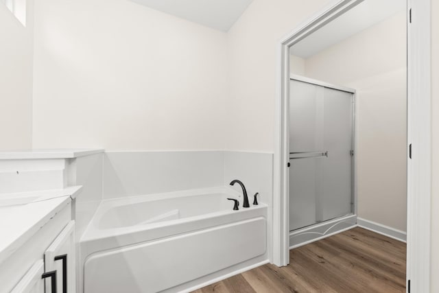 1468 W Grand Haven Rd, Romeoville, IL 60446 - bathroom featuring a bath, wood finished floors, a shower stall, vanity, and baseboards