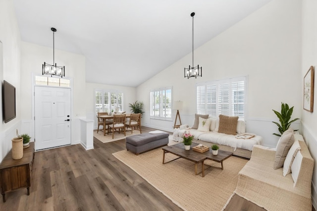 1468 W Grand Haven Rd, Romeoville, IL 60446 - living room featuring a chandelier, high vaulted ceiling, wood finished floors, and baseboards