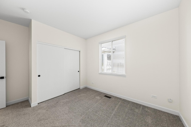 1468 W Grand Haven Rd, Romeoville, IL 60446 - unfurnished bedroom with carpet floors, baseboards, and a closet
