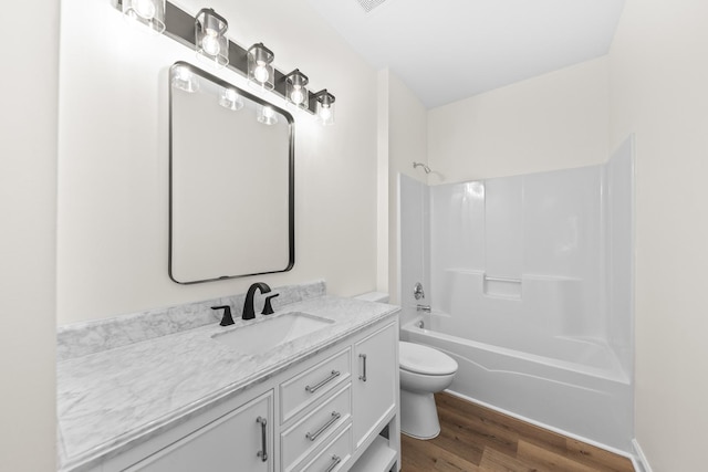 1468 W Grand Haven Rd, Romeoville, IL 60446 - bathroom featuring toilet, wood finished floors, vanity, and tub / shower combination