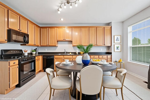 412 W Wood St, Palatine, IL 60067 - kitchen featuring black appliances, a sink, dark countertops, light tile patterned floors, and baseboards