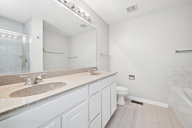 412 W Wood St, Palatine, IL 60067 - bathroom featuring tile patterned floors, double vanity, a garden tub, toilet, and a stall shower