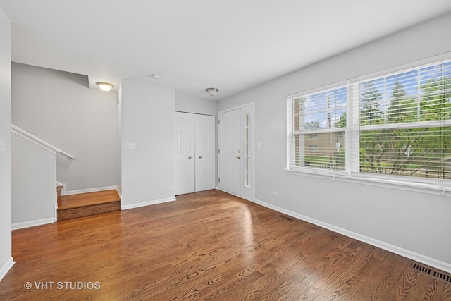 412 W Wood St, Palatine, IL 60067 - empty room featuring healthy amount of natural light, baseboards, stairs, and wood finished floors