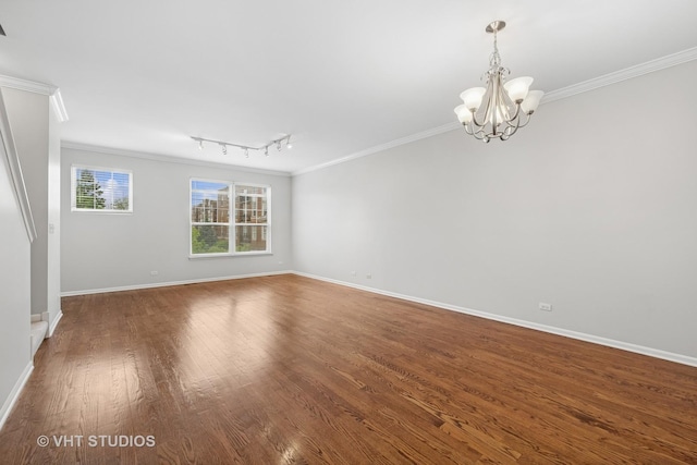 412 W Wood St, Palatine, IL 60067 - spare room with ornamental molding, a chandelier, baseboards, wood finished floors, and track lighting