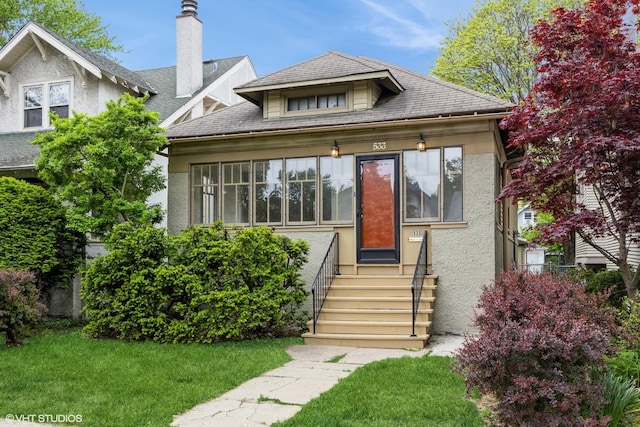 533 Clarence Ave, Oak Park, IL 60304 - view of front of house featuring stucco siding, a front yard, and entry steps