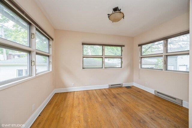533 Clarence Ave, Oak Park, IL 60304 - spare room featuring a baseboard radiator, light wood-style floors, and baseboards