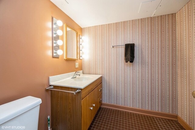 533 Clarence Ave, Oak Park, IL 60304 - bathroom featuring wallpapered walls, toilet, vanity, baseboards, and tile patterned floors