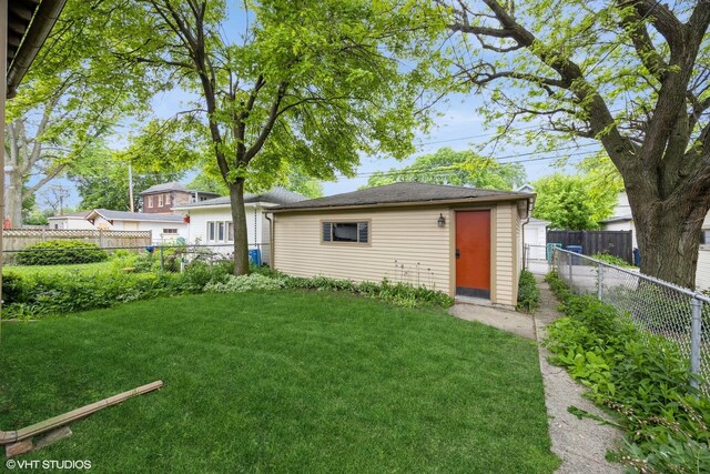 533 Clarence Ave, Oak Park, IL 60304 - rear view of house with an outdoor structure and a storage unit