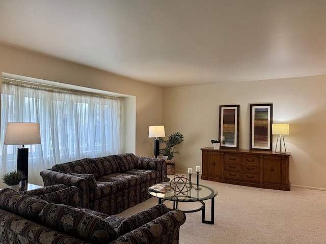 living room with healthy amount of natural light, carpet, and baseboards
