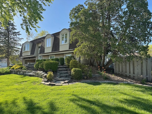 view of front of home featuring mansard roof, roof with shingles, and stairs