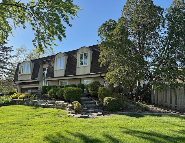 view of front of home featuring a shingled roof, mansard roof, and brick siding