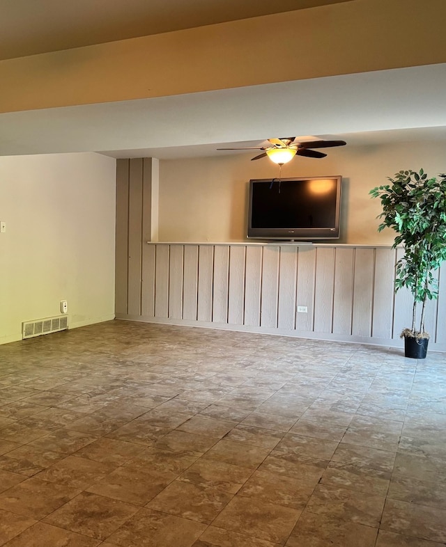unfurnished living room featuring a ceiling fan