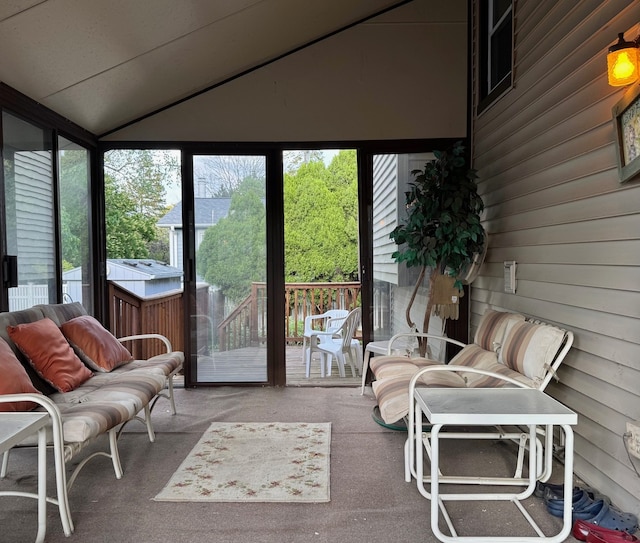 sunroom / solarium featuring healthy amount of natural light and lofted ceiling