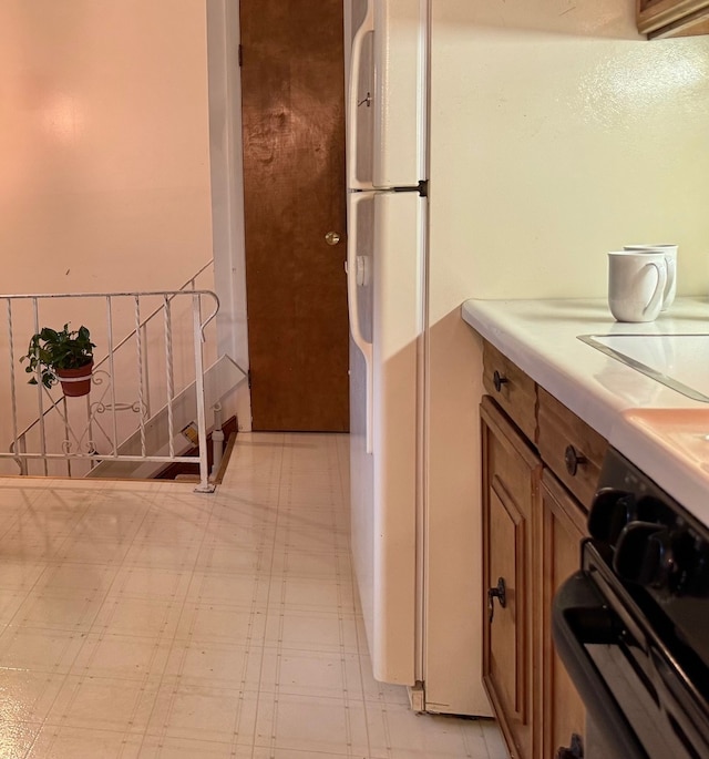 kitchen featuring light flooring, brown cabinetry, and light countertops