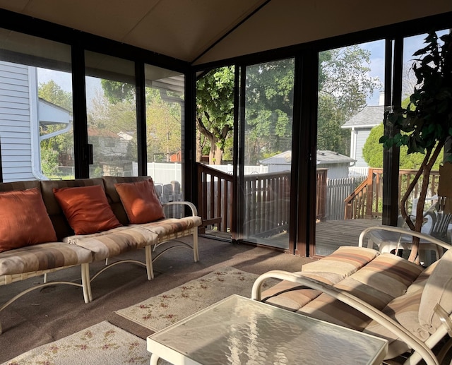 sunroom featuring outdoor lounge area and vaulted ceiling