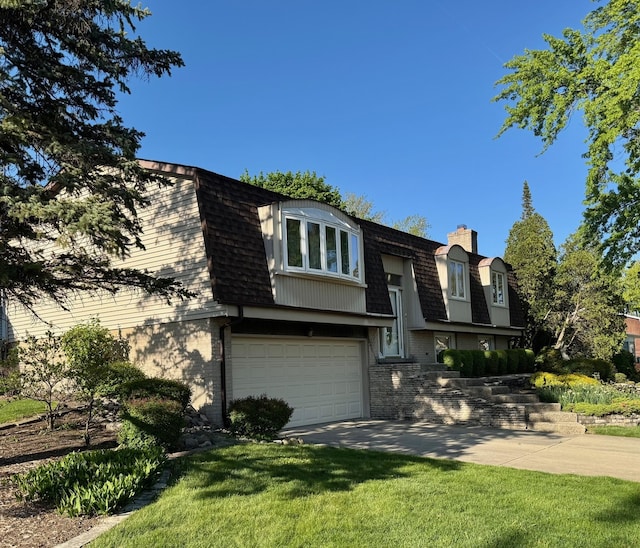 view of front of house with a shingled roof, an attached garage, a chimney, mansard roof, and a front yard