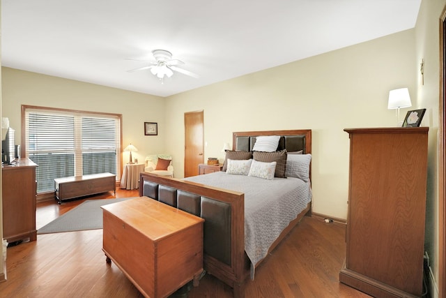 bedroom with wood finished floors, ceiling fan, and baseboards