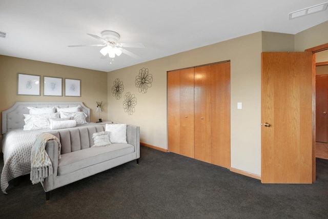 bedroom with dark colored carpet, a closet, and ceiling fan
