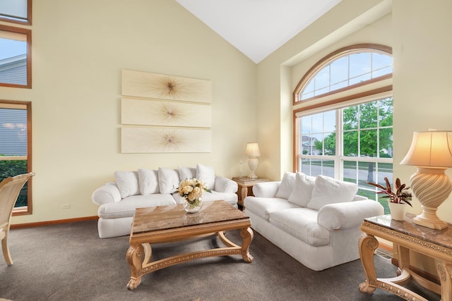 carpeted living room featuring high vaulted ceiling and baseboards