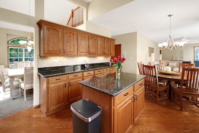 kitchen featuring a chandelier, plenty of natural light, light wood-style floors, and brown cabinetry