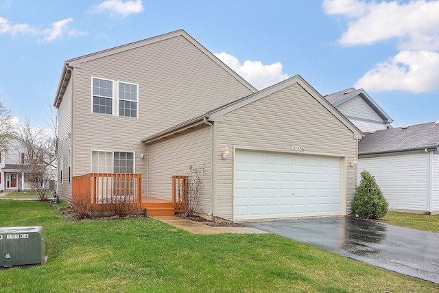 21536 Vesper St, Crest Hill, IL 60403 - view of front facade with asphalt driveway, a wooden deck, a front lawn, and an attached garage