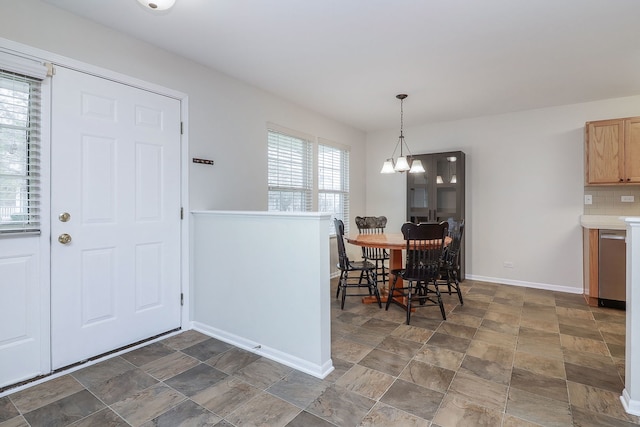 21536 Vesper St, Crest Hill, IL 60403 - dining area featuring a chandelier, baseboards, and stone finish floors