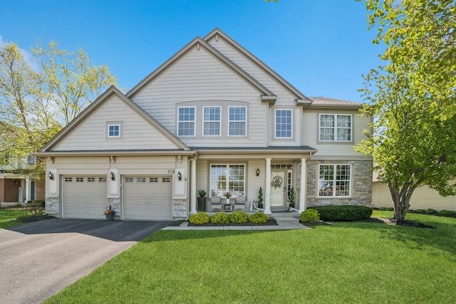 718 Northgate Dr, Sycamore, IL 60178 - view of front facade featuring stone siding, asphalt driveway, a front lawn, covered porch, and an attached garage