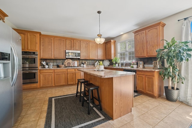 718 Northgate Dr, Sycamore, IL 60178 - kitchen featuring stainless steel appliances, light tile patterned floors, and decorative backsplash