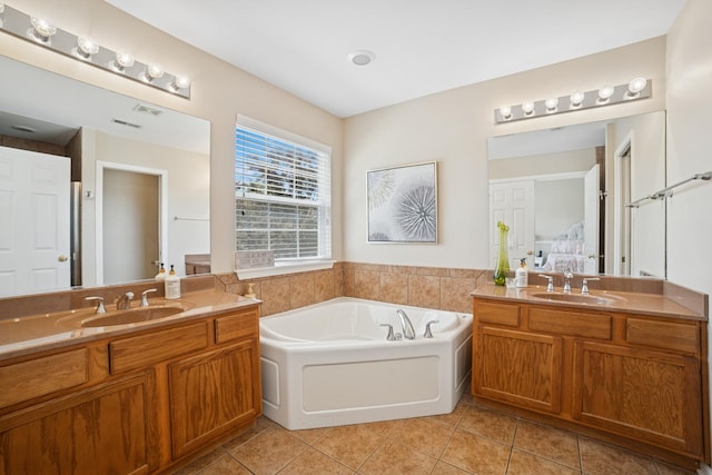 718 Northgate Dr, Sycamore, IL 60178 - full bath featuring tile patterned flooring, a bath, connected bathroom, and two vanities