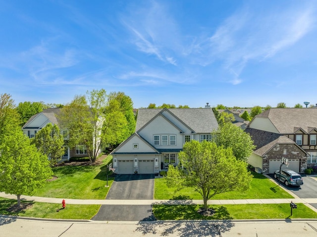 718 Northgate Dr, Sycamore, IL 60178 - view of front facade with driveway, a front lawn, an attached garage, and a residential view