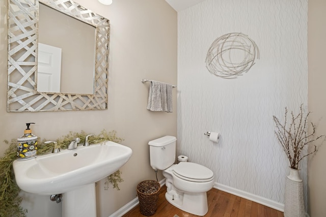 718 Northgate Dr, Sycamore, IL 60178 - half bath featuring wood finished floors, toilet, baseboards, and a sink