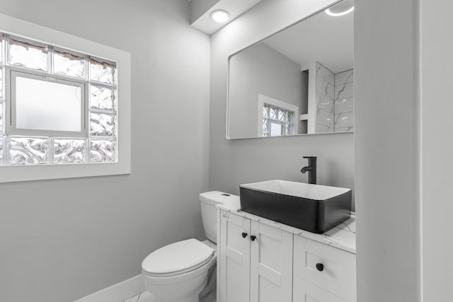 12725 S Wallace St, Chicago, IL 60628 - bathroom with plenty of natural light, baseboards, toilet, and vanity