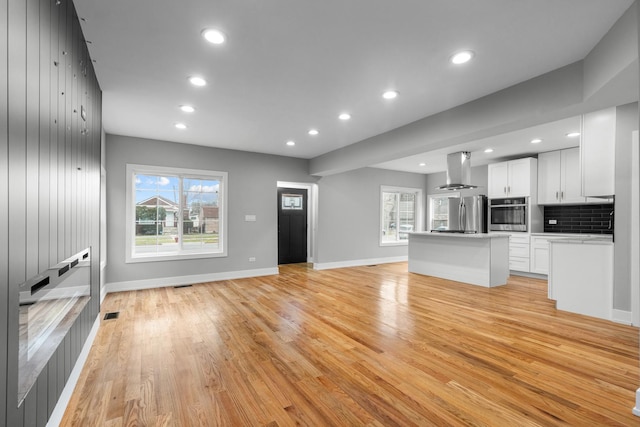 12725 S Wallace St, Chicago, IL 60628 - unfurnished living room with light wood-style floors, recessed lighting, and baseboards