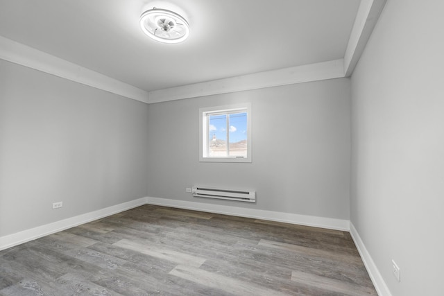 12725 S Wallace St, Chicago, IL 60628 - spare room featuring a baseboard heating unit, wood finished floors, and baseboards