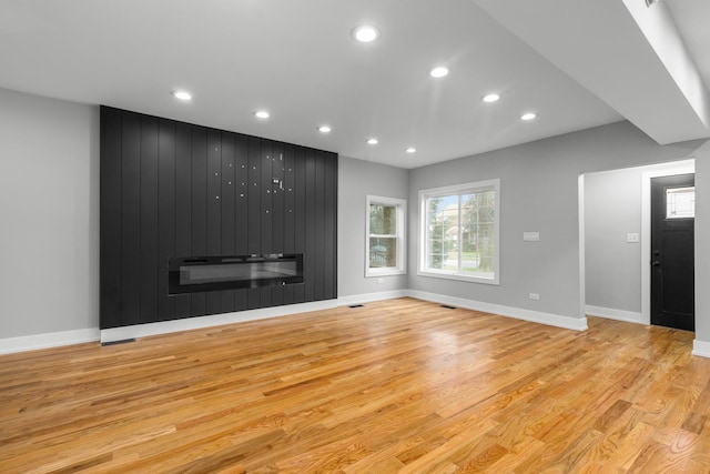 12725 S Wallace St, Chicago, IL 60628 - unfurnished living room with recessed lighting, light wood-style flooring, a fireplace, and baseboards