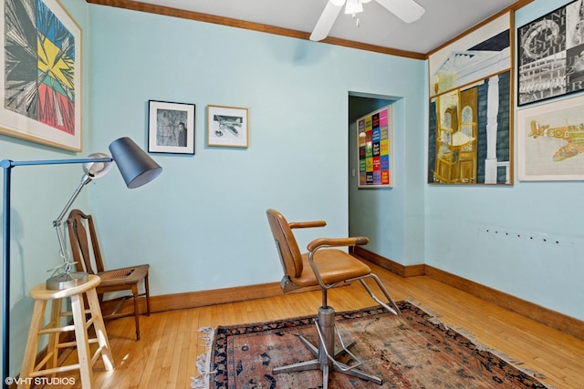 office featuring crown molding, hardwood / wood-style floors, baseboards, and a ceiling fan