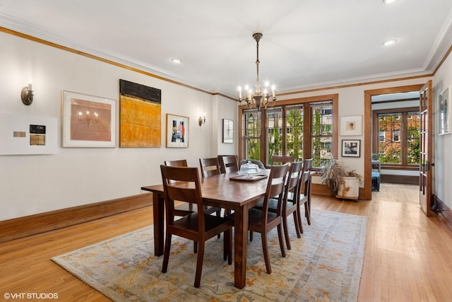 dining space with a chandelier, light wood finished floors, crown molding, baseboards, and recessed lighting
