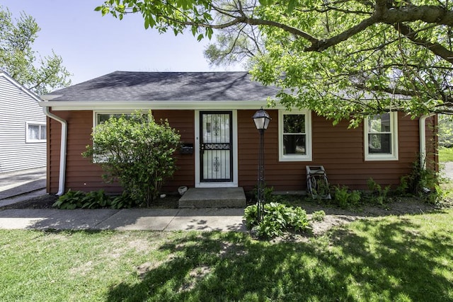 1705 Lyons Ct, Waukegan, IL 60085 - view of front facade with a front yard and a shingled roof