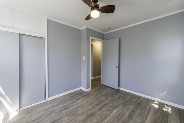 1705 Lyons Ct, Waukegan, IL 60085 - unfurnished bedroom featuring wood finished floors, baseboards, crown molding, a closet, and ceiling fan