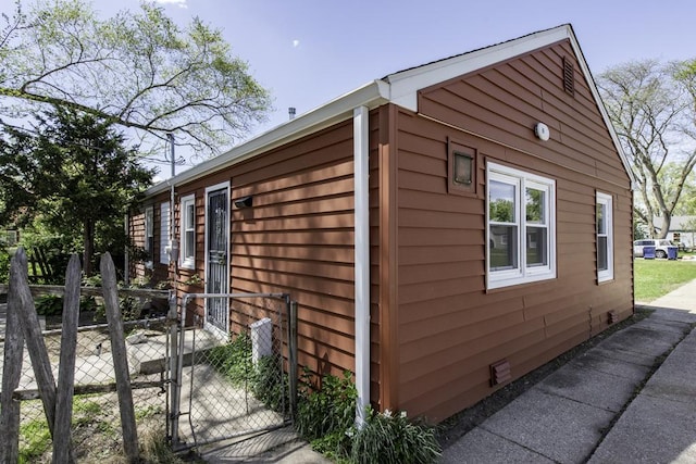 1705 Lyons Ct, Waukegan, IL 60085 - view of home's exterior with crawl space, a gate, and fence